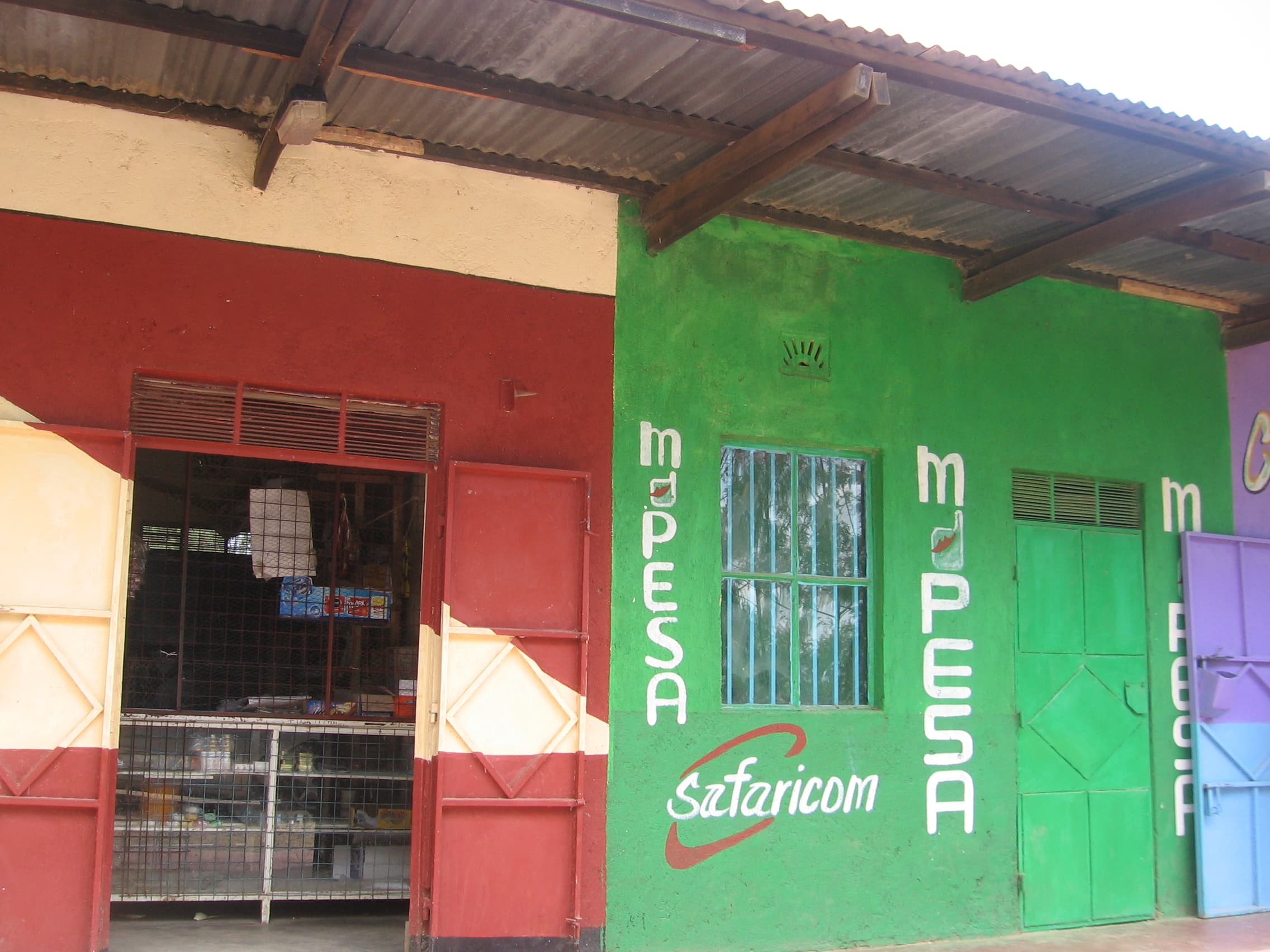 An M-Pesa kiosk in Kenya. Mobile money, led by M-Pesa, now accounts for 44% of Safaricom's revenue in its home market — and control of that payments rail is the strategic core of Vodacom's move to majority ownership. Illustrative file photo.