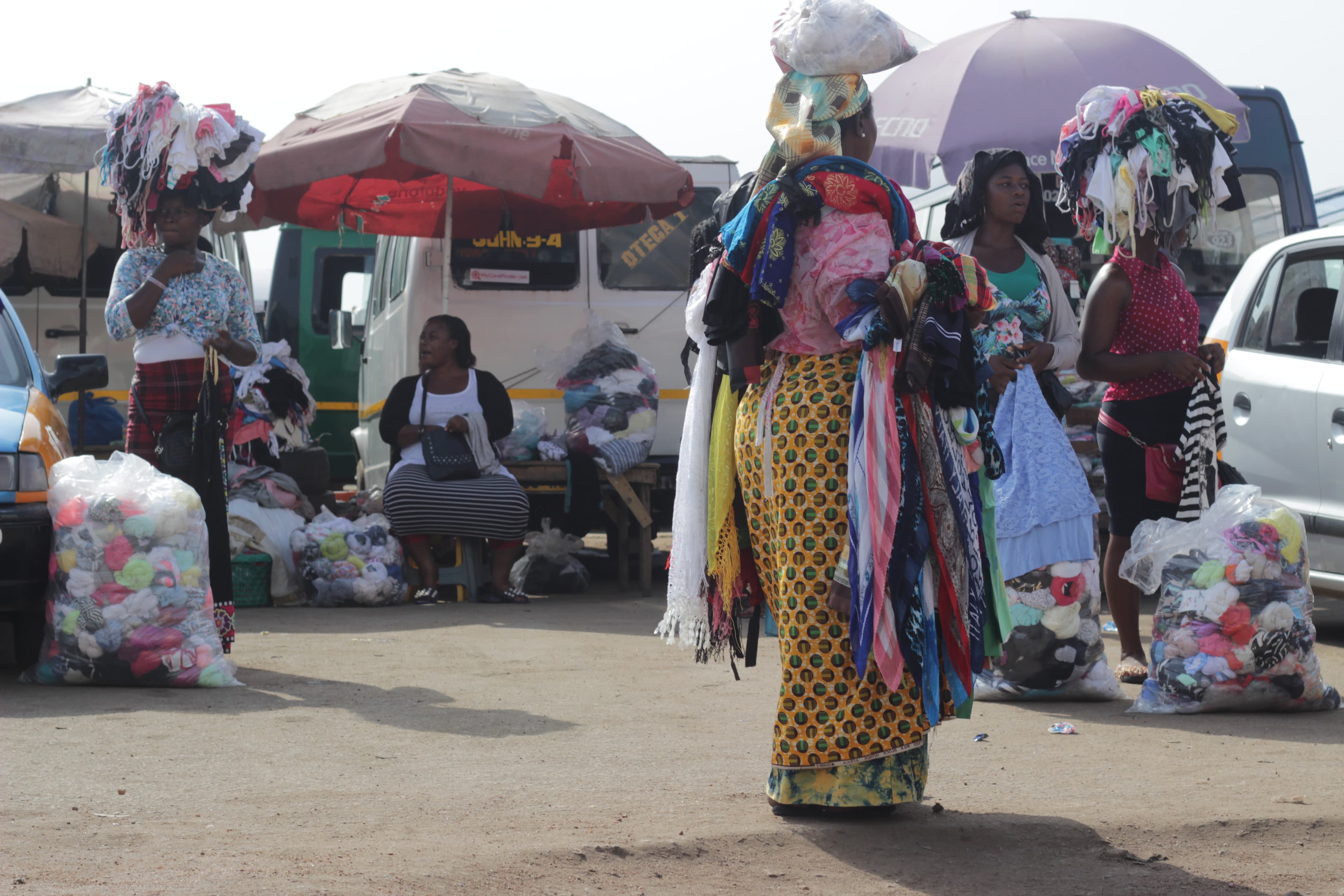 A vendor sells secondhand clothing at a market in Ghana. Illustrative of West Africa's imported used-clothing trade — not a photograph of Maket, which operates in Senegal.
