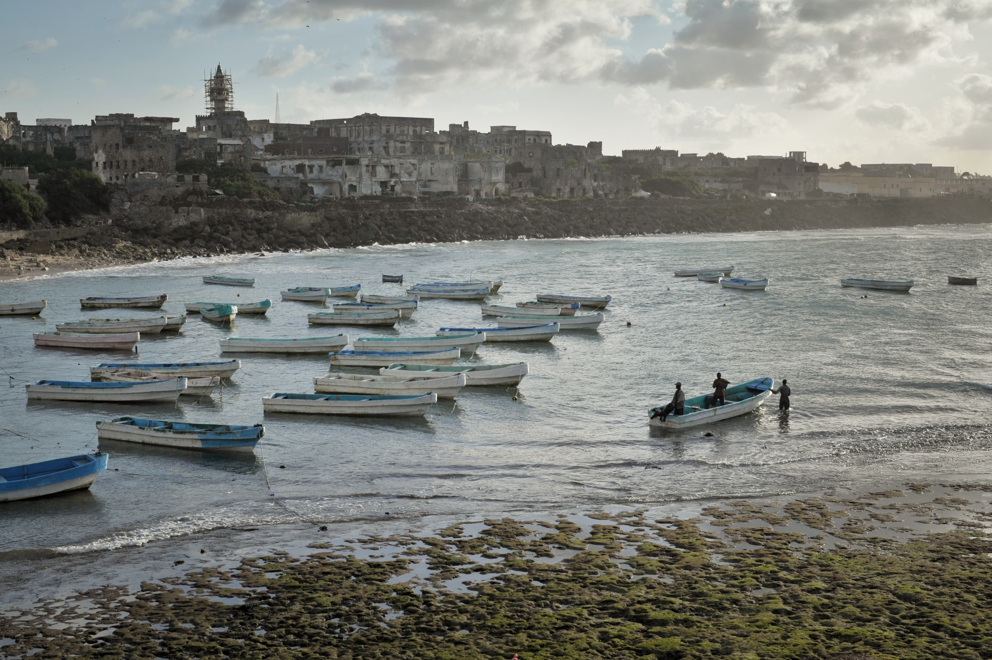 Illustrative: the sun rises over Mogadishu's old port, roughly 370 km from the Curad-1 drilling site off Somalia's coast.