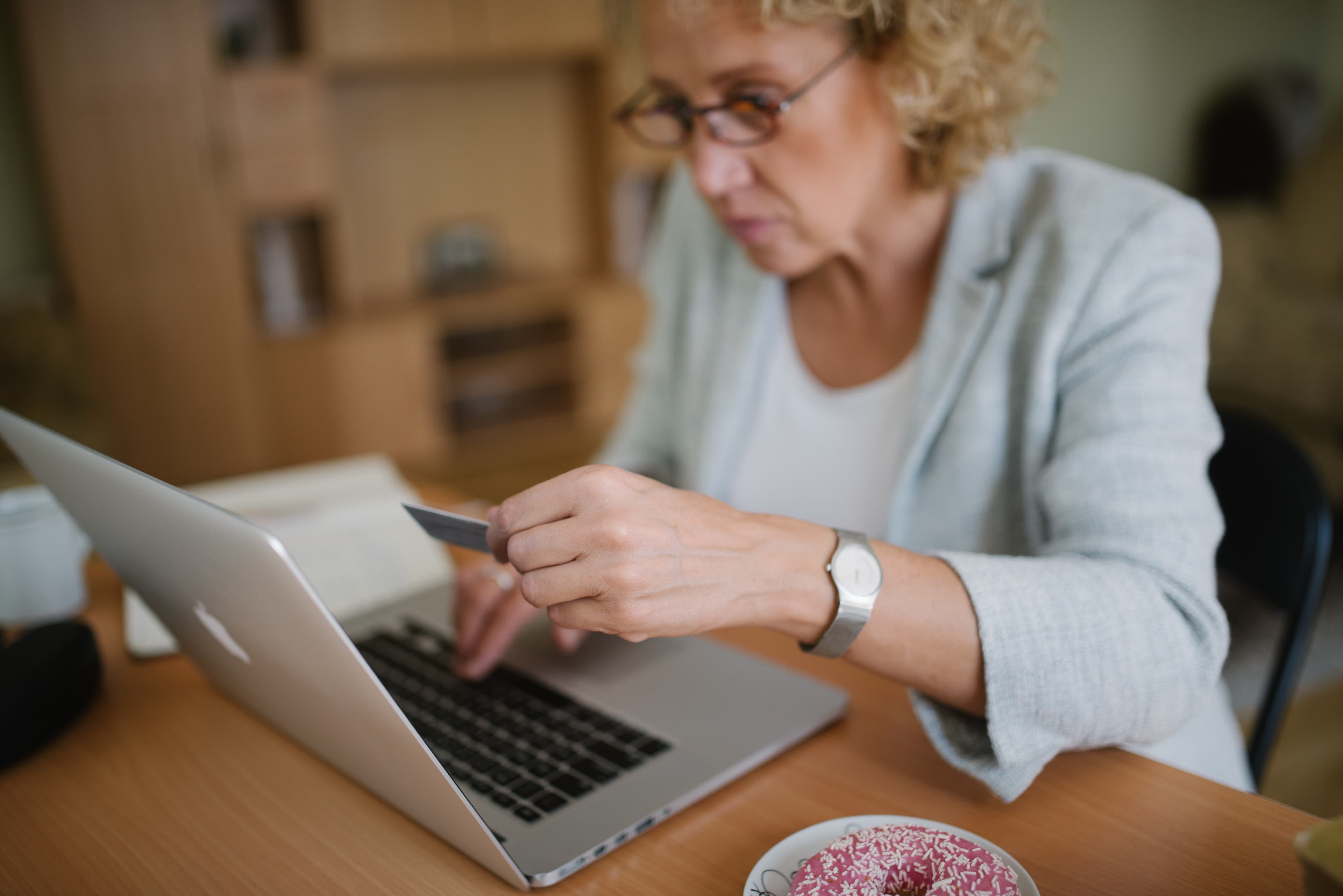 Illustrative: a professional working at a laptop. Not an OpenAI customer specifically, but representative of the knowledge-work tasks OpenAI's scorecard is designed to measure.