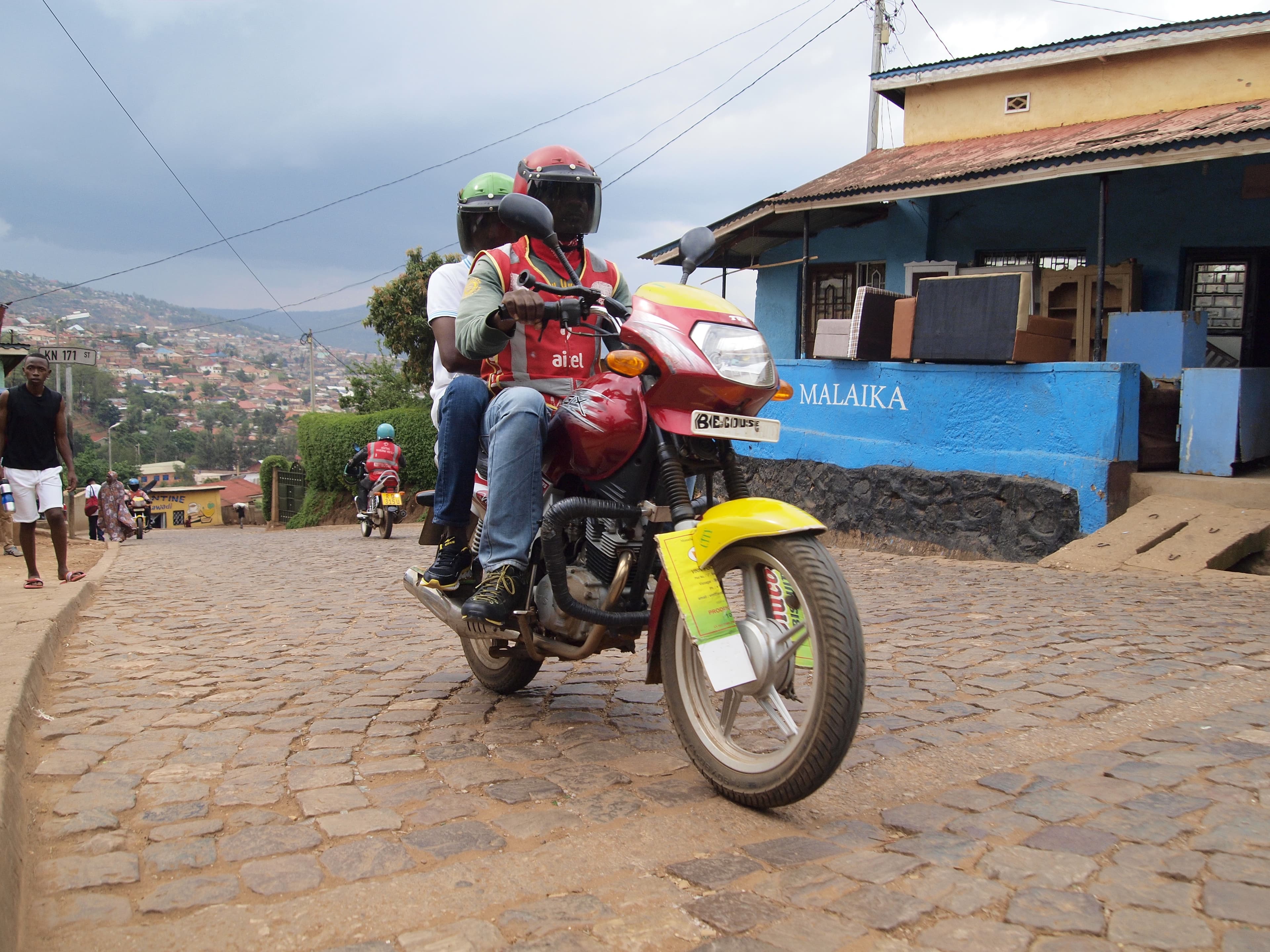 Illustrative: a petrol motorcycle taxi in Kigali, Rwanda — the conventional boda-boda model that Spiro's electric, battery-swapping motorcycles are built to replace across seven African markets.