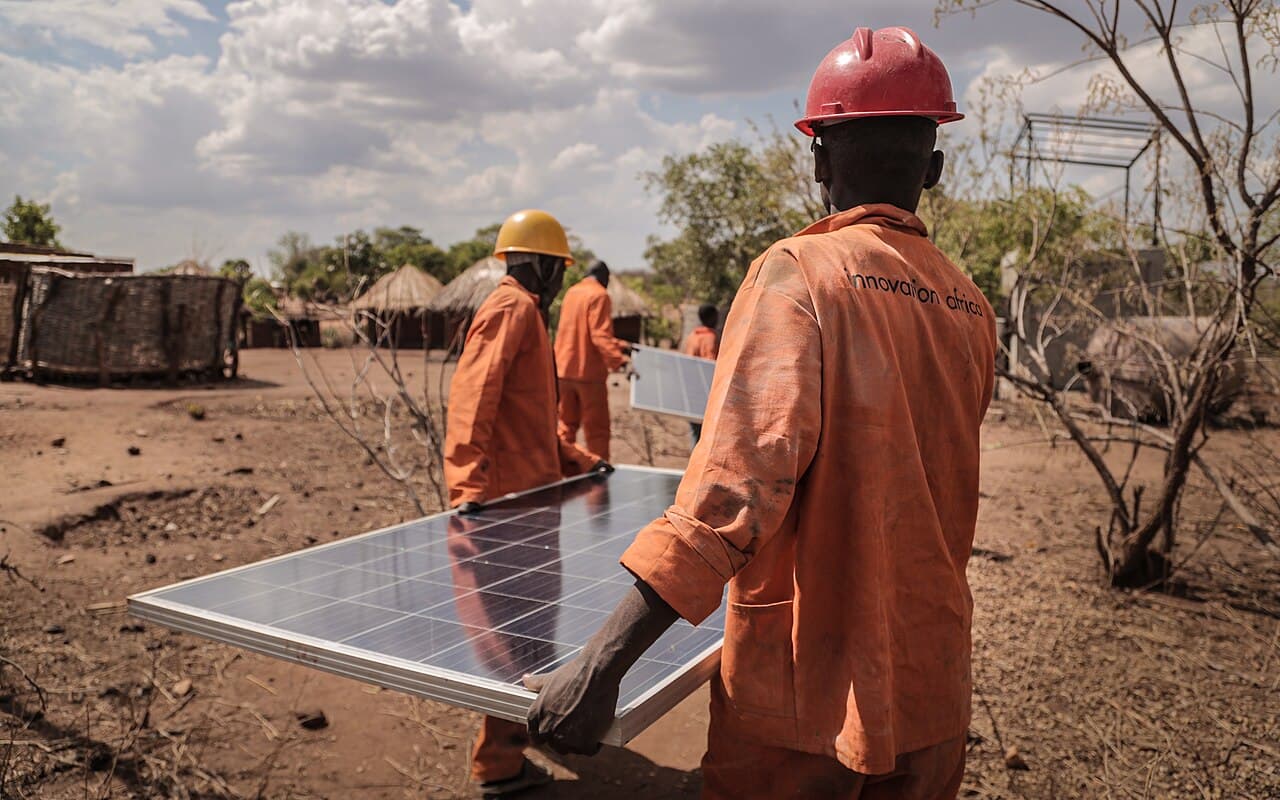 Solar panels powering a rural African community. Illustrative: decentralised solar is expanding electricity access across the continent, the market WeLight is betting $650m on.