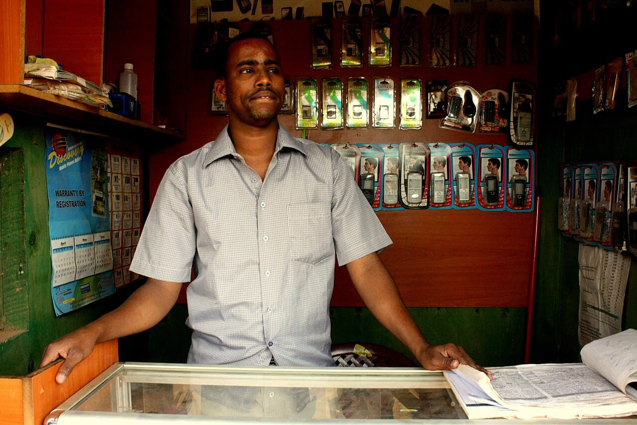 A mobile-phone shop in East Africa. Operators serving the region argue that AI which understands local languages would bring hundreds of millions of currently excluded users into the digital economy. (Illustrative)